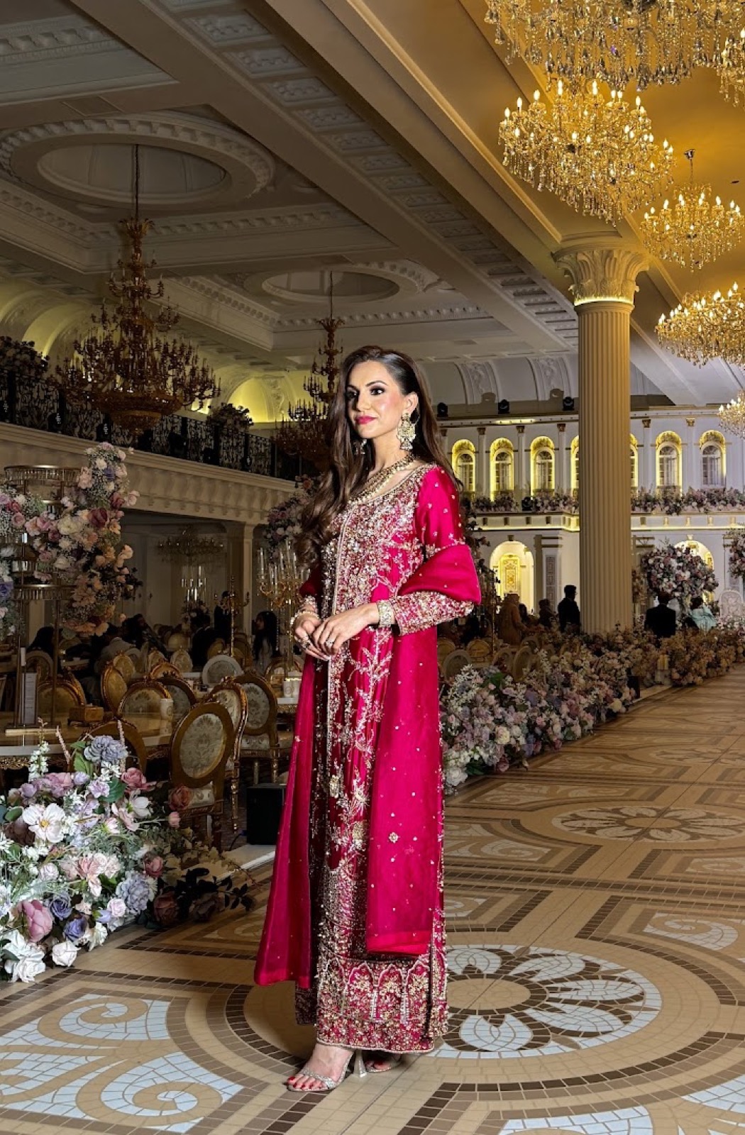 Bride in a hand-embroidered magenta bridal outfit by Kanval By Design