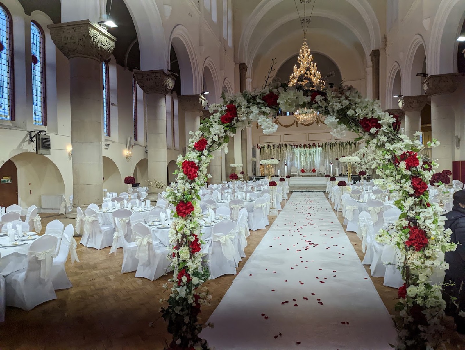 Usmania Banqueting Hall dressed for a wedding — floral aisle beneath a grand chandelier