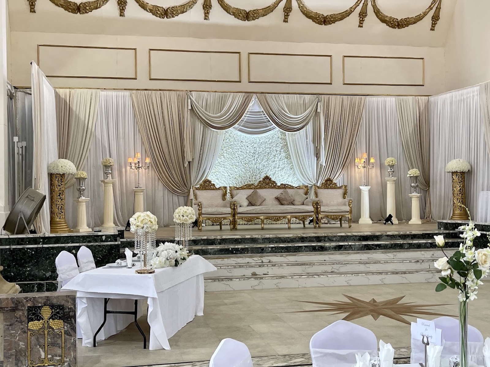 Stage with draped backdrop and sofa